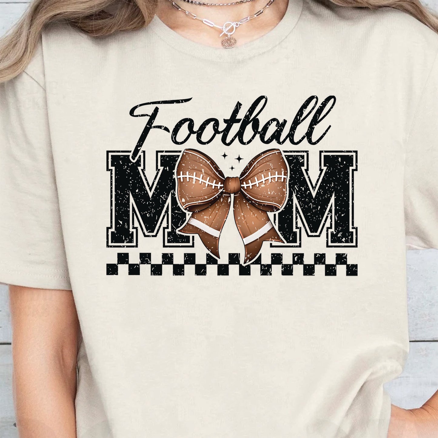 Cute sports mom game day outfit with football mom graphic tee
